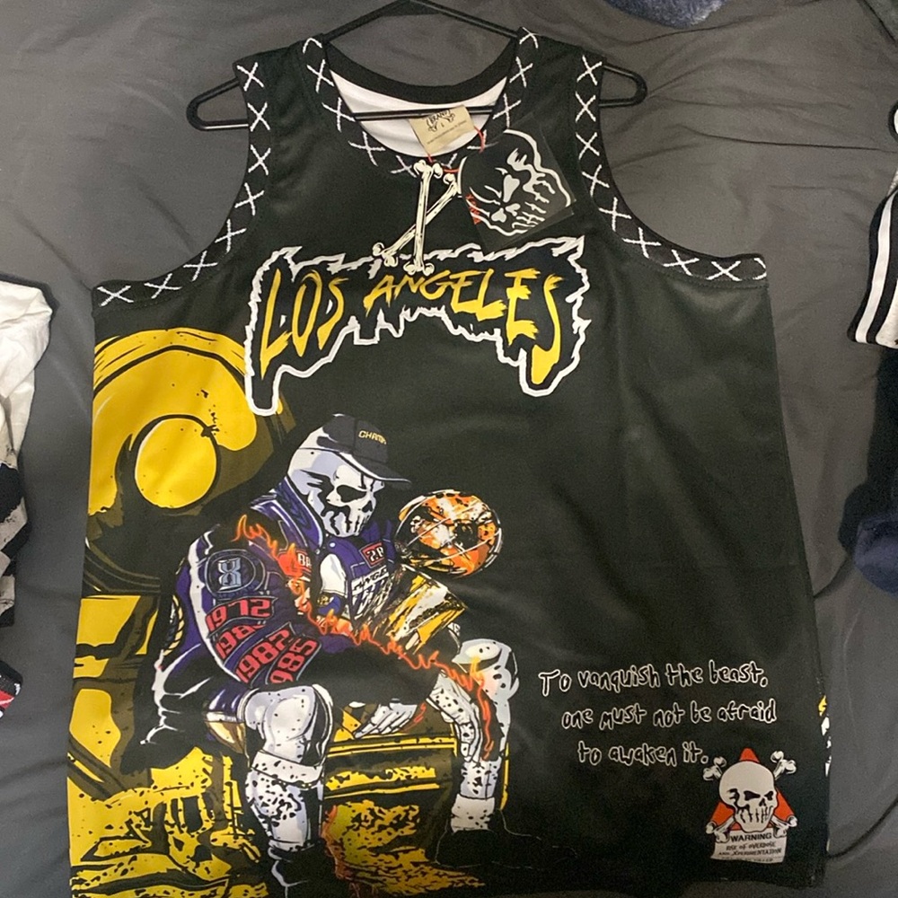 Kobe Bryant jersey from brand X (Allstarelite). Kobe holding LA laker trophy.